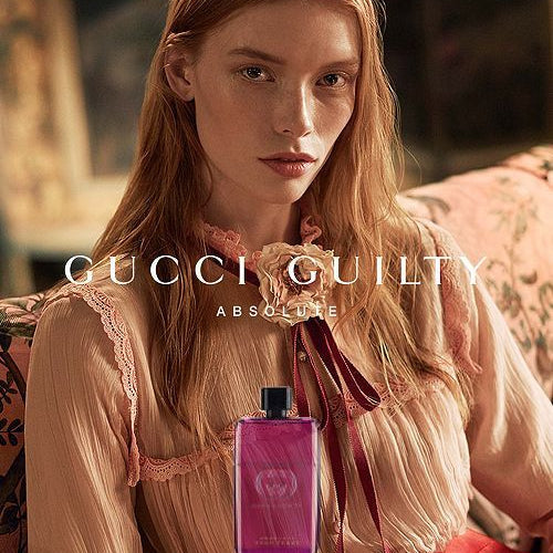 Refect Beauty Gucci Guilty Absolute Pour Femme perfume bottle featuring a deep berry glass design in a vintage setting