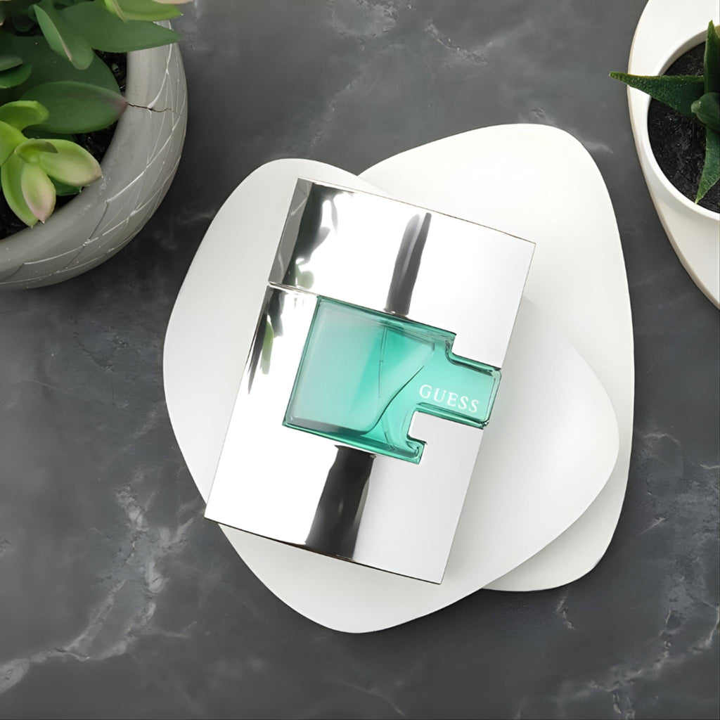 Refect Beauty Guess for Men Eau De Toilette bottle with a silver metallic frame and green glass on a white plate