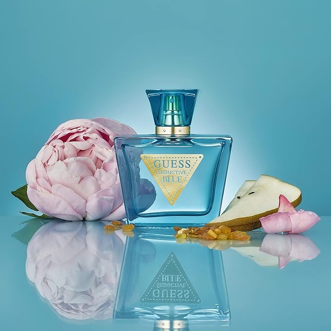 Refect Beauty Guess Seductive Blue Eau de Toilette bottle with peony flower and pear slices on a reflective surface