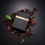 Refect Beauty Guess Seductive Homme Noir fragrance bottle surrounded by black pepper, amber stones, and orange blossoms.