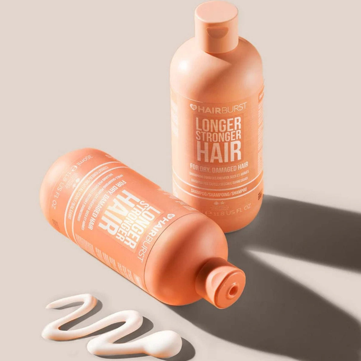Refect Beauty Hair Burst conditioner bottles in peach packaging for dry and damaged hair with a cream swirl