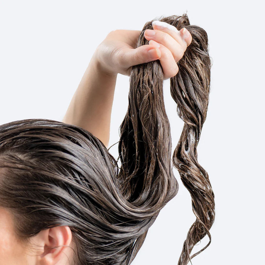 Refect Beauty Hair Burst shampoo and conditioner applied to wet hair to promote longer and stronger strands