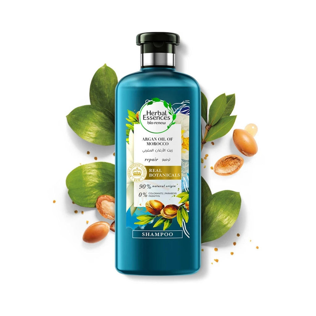 Refect Beauty Herbal Essences Argan Oil of Morocco shampoo bottle surrounded by argan nuts and green leaves.