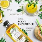 Refect Beauty Herbal Essences Golden Moringa Oil shampoo bottle surrounded by citrus, white florals, and coconut.