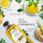 Refect Beauty Herbal Essences Golden Moringa Oil shampoo bottle surrounded by citrus, white florals, and coconut water.