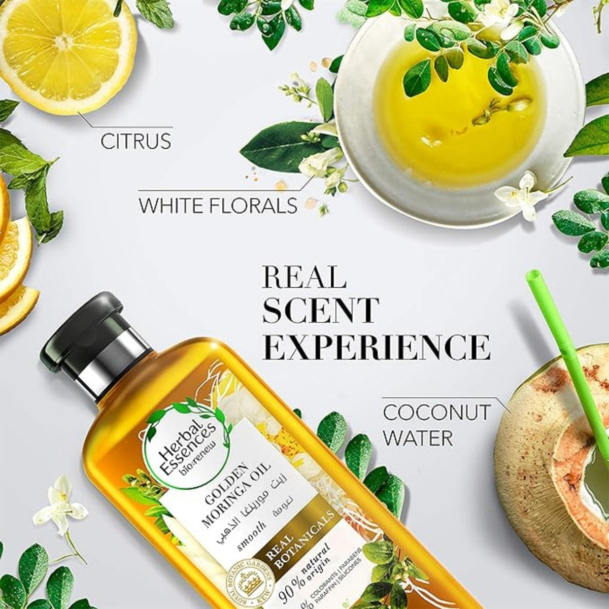 Refect Beauty Herbal Essences Golden Moringa Oil shampoo bottle surrounded by citrus, white florals, and coconut water.