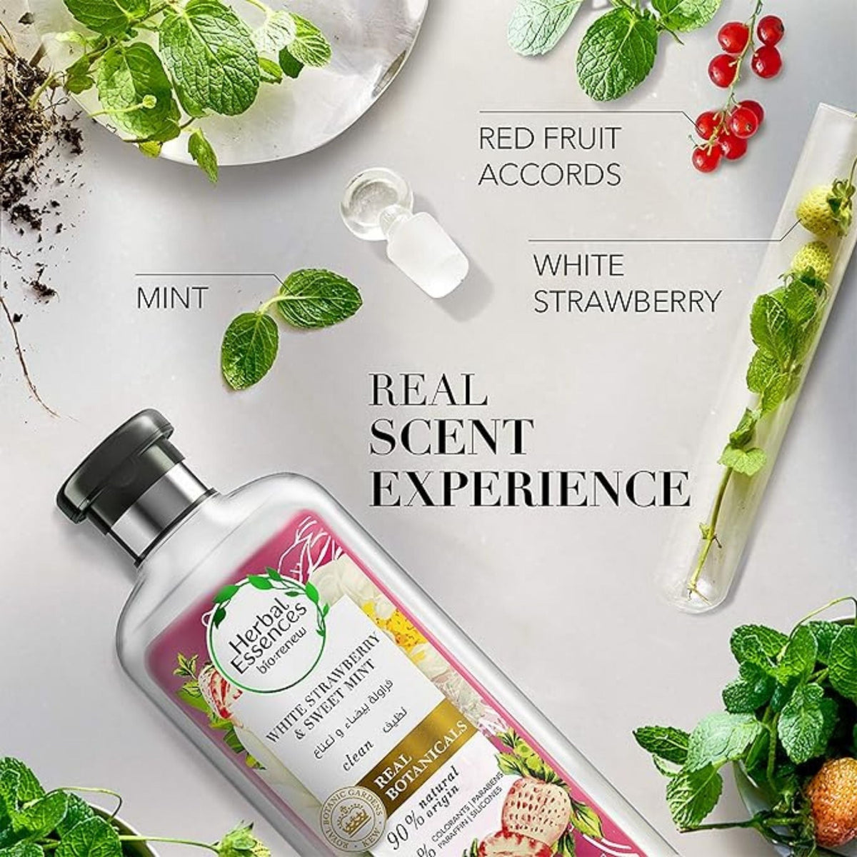 Refect Beauty Herbal Essences White Strawberry and Sweet Mint shampoo bottle surrounded by fresh mint and berries