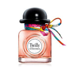 Refect Beauty Hermès Twilly d’Hermès Eau de Parfum bottle with a black cap and a colorful silk ribbon tie.