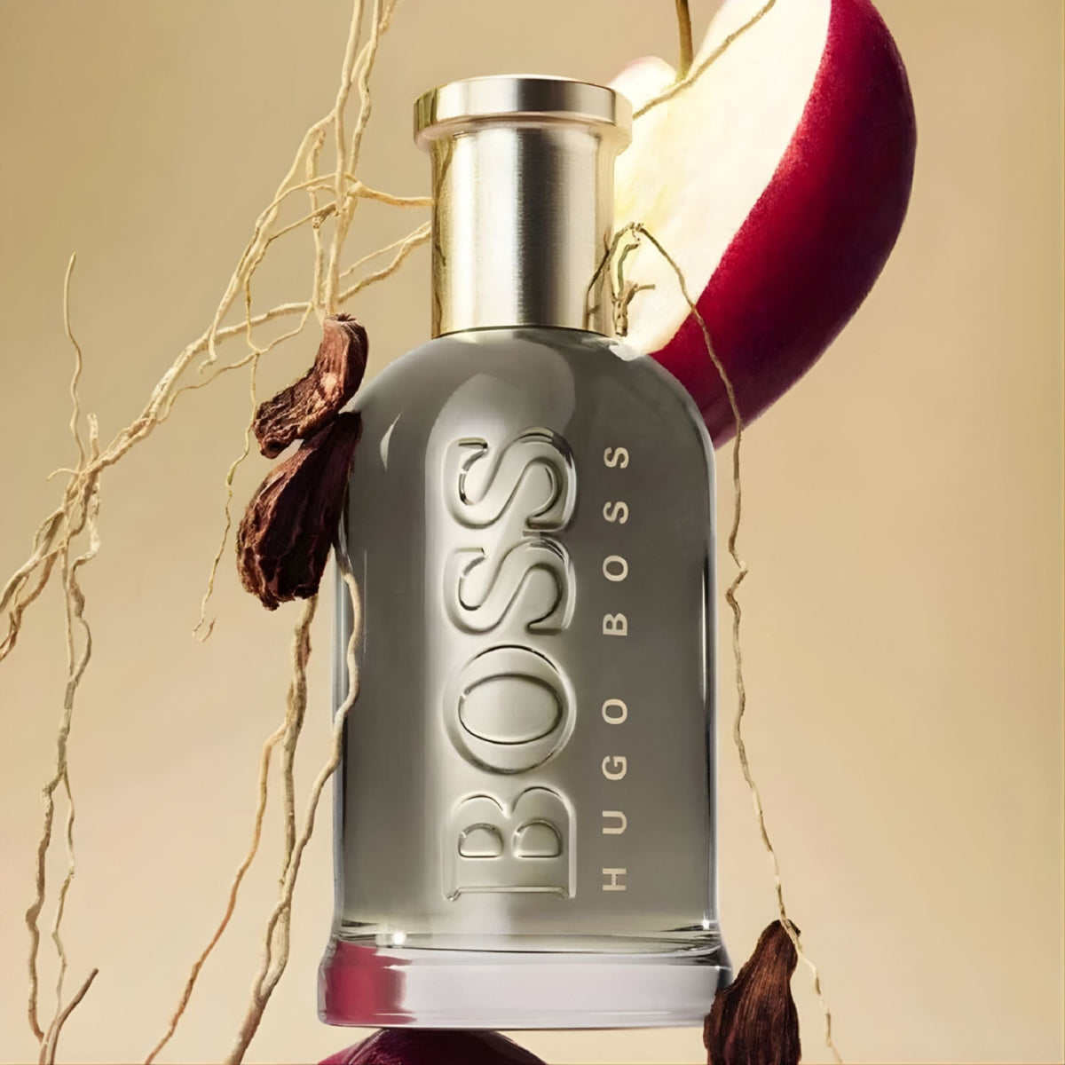 Refect Beauty Hugo Boss Bottled Eau de Parfum bottle with apple and spice accents on a warm beige background