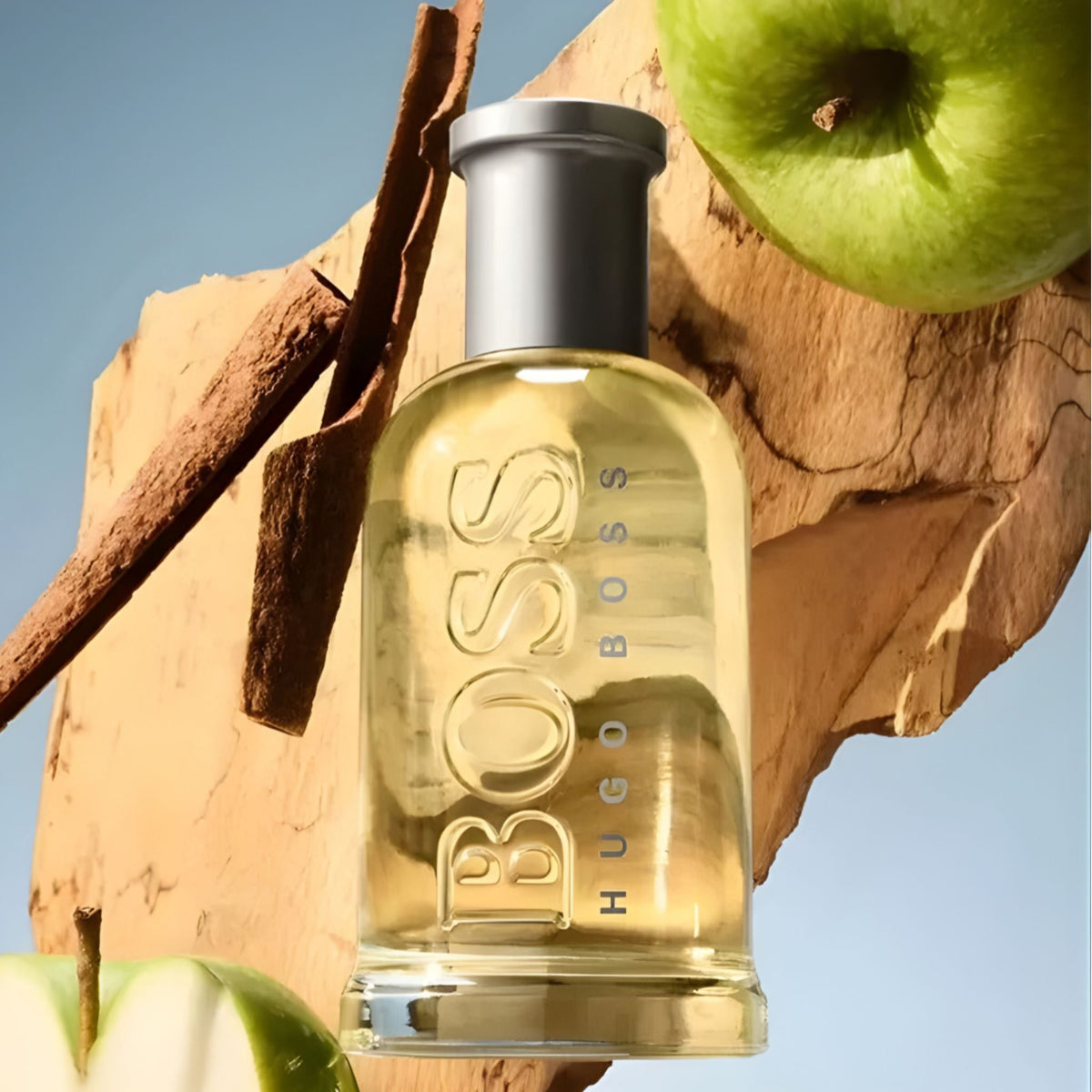 Refect Beauty Hugo Boss Bottled Eau de Toilette fragrance bottle surrounded by fresh green apples and cinnamon sticks