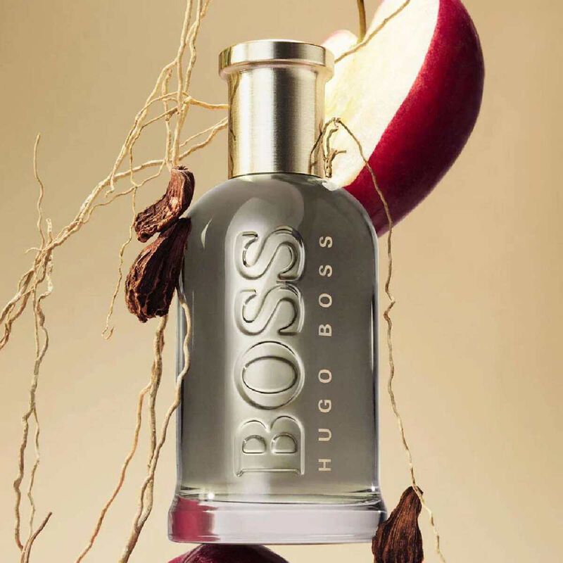 Refect Beauty Hugo Boss Bottled Eau de Parfum bottle with apple and spice accents on a warm beige background