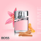 Refect Beauty Hugo Boss Femme Eau de Parfum bottle with pink lily, tangerine, and wood accents on a soft pink background