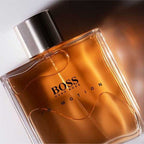 Refect Beauty Hugo Boss In Motion Eau de Toilette in a signature round orange glass bottle with a metallic cap.