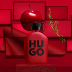 Refect Beauty Hugo Boss Intense eau de parfum bottle in a red studio setting with an apple and rosemary sprig