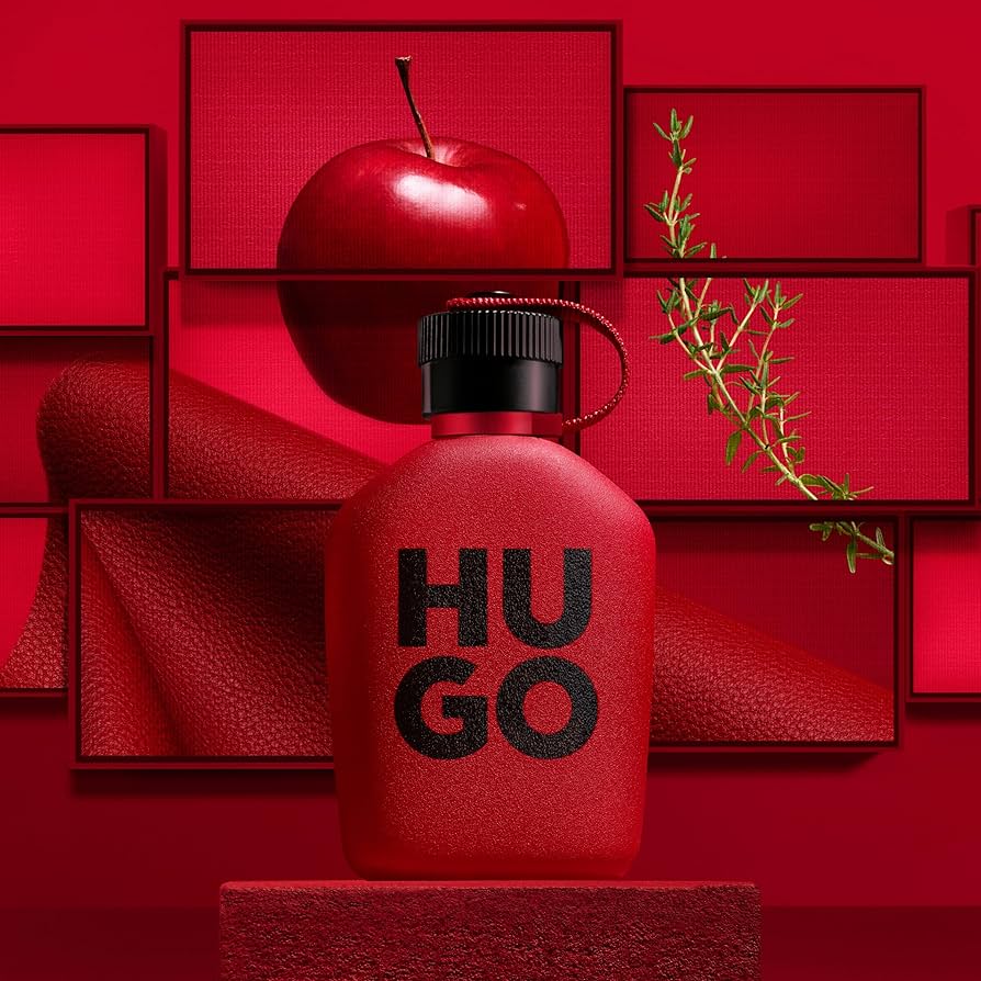Refect Beauty Hugo Boss Intense eau de parfum bottle in a red studio setting with an apple and rosemary sprig