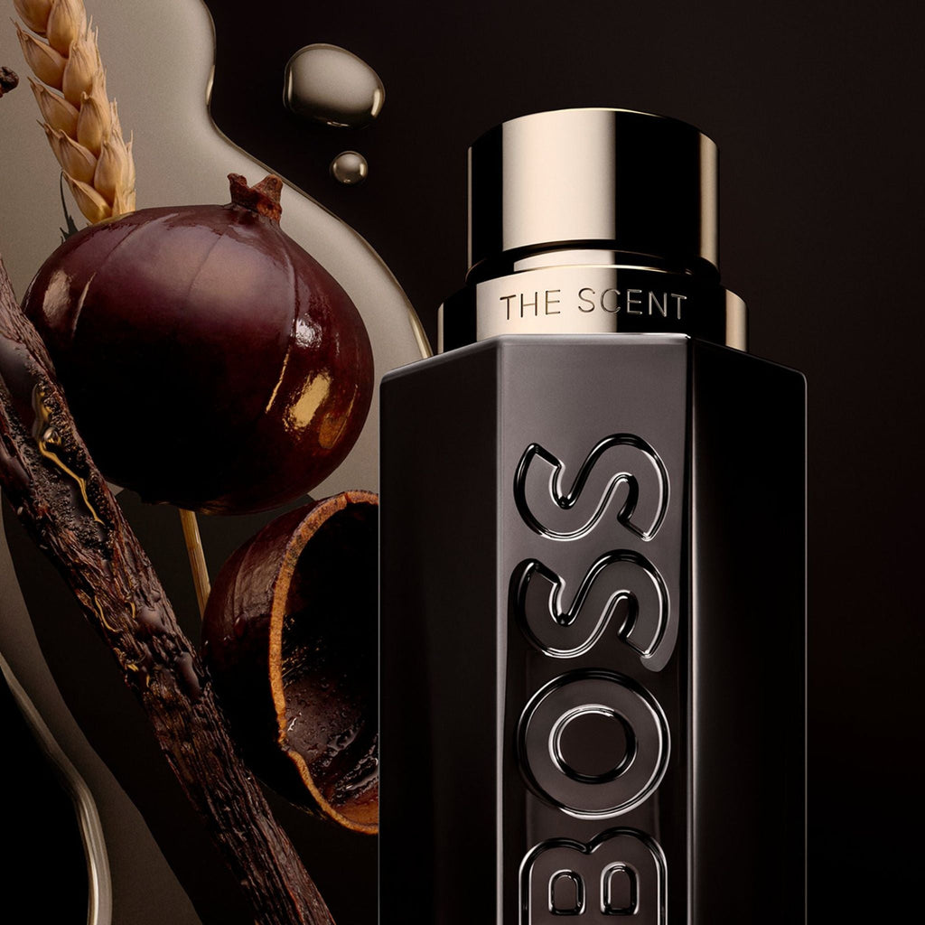 Refect Beauty Hugo Boss The Scent Magnetic perfume bottle with maninka fruit, bran, and vanilla husk on dark background