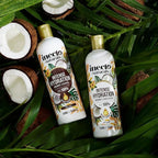 Refect Beauty Inecto Naturals coconut shampoo and conditioner bottles on a bed of tropical palm leaves and coconuts.