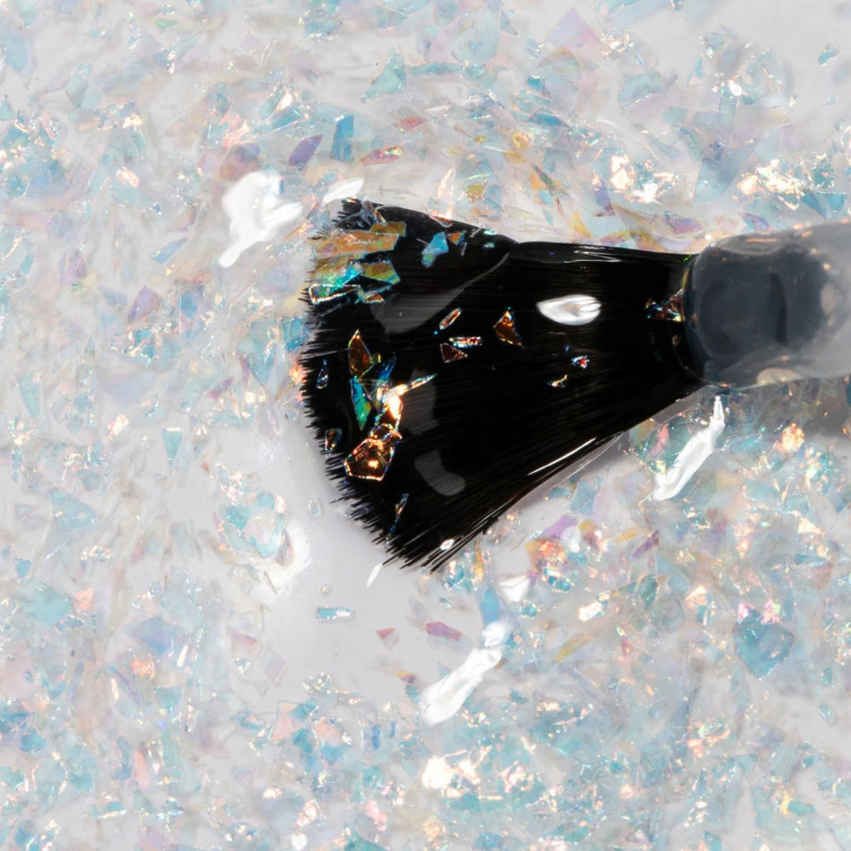 Refect Beauty Astra Lasting Gel Effect nail polish brush coated in iridescent holographic glitter flakes