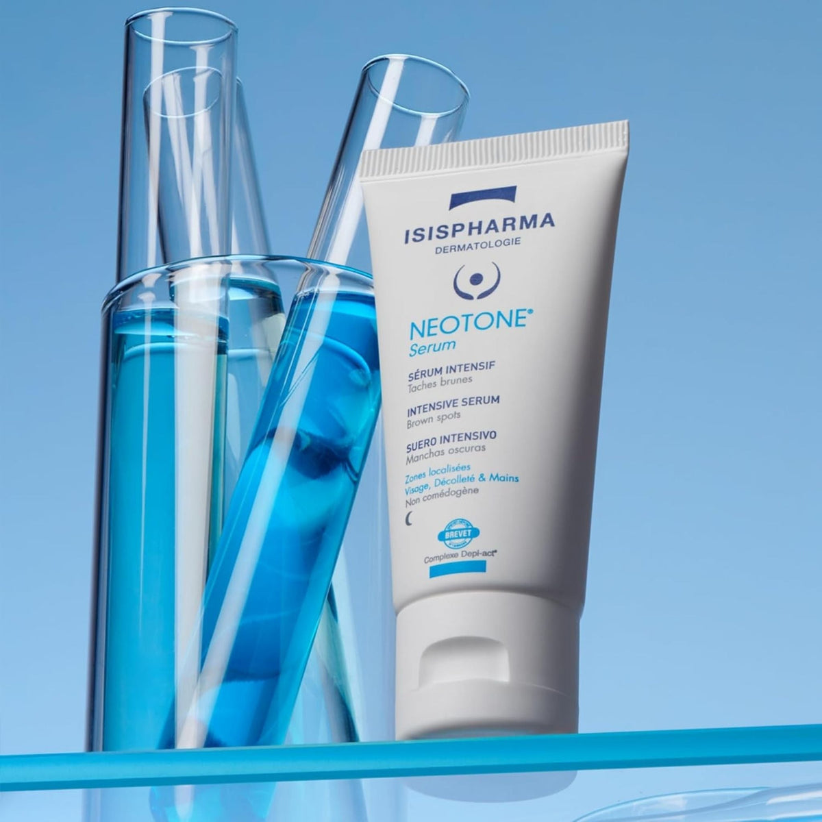 Refect Beauty Isispharma Neotone Serum in a white tube next to glass test tubes filled with blue liquid.