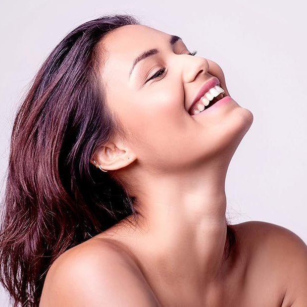 Refect Beauty Isispharma Vitiskin hydrogel user with radiant, even-toned skin smiling against a neutral background