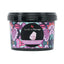 Refect Beauty Jardin Flamingo Cotton Candy face and body scrub in a decorative black tub with vibrant floral patterns.