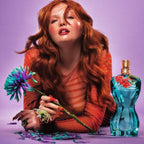 Refect Beauty model with red hair holding a blue flower next to Jean Paul Gaultier La Belle Paradise Garden perfume