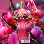 Refect Beauty Jean Paul Gaultier La Belle Rosea perfume bottle with gold rose and garnet accents amidst pink flowers