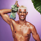 Refect Beauty model holding Jean Paul Gaultier Le Beau Paradise Garden perfume bottle against a purple background