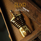 Refect Beauty Jean Paul Gaultier Le Male Elixir Parfum in a gold torso-shaped bottle with black stripes