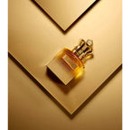 Refect Beauty Jean Paul Gaultier Scandal Absolu Pour Homme perfume bottle with a gold crown cap on a gold background