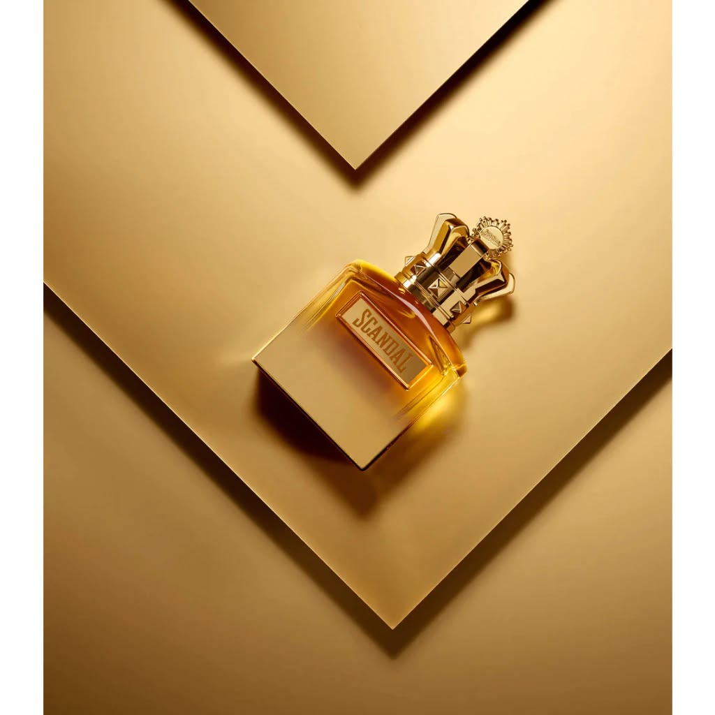 Refect Beauty Jean Paul Gaultier Scandal Absolu Pour Homme perfume bottle with a gold crown cap on a gold background