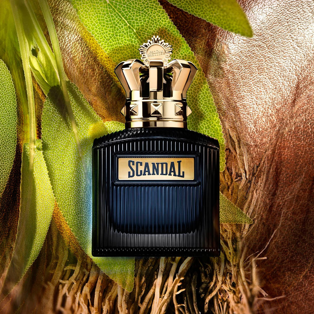 Refect Beauty Jean Paul Gaultier Scandal Intense perfume bottle with gold crown cap on sage leaves and leather texture