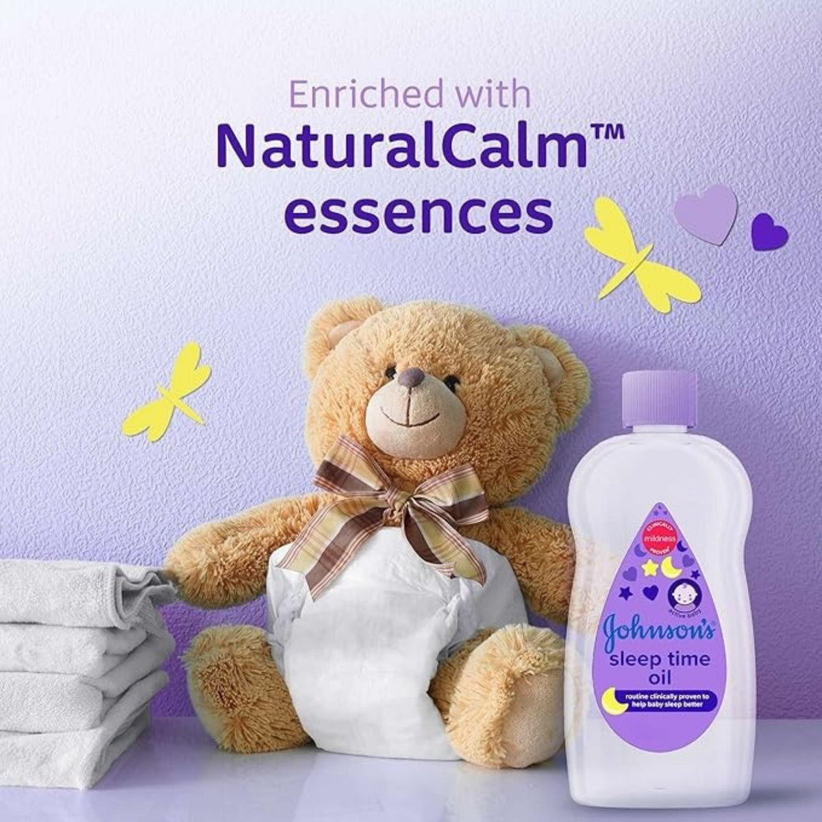 Refect Beauty Johnsons Sleep Time Baby Oil bottle next to a teddy bear on a purple background with calming graphics