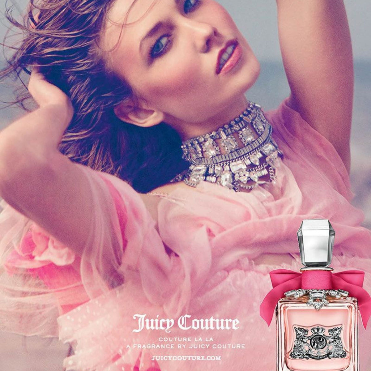 Refect Beauty advertisement for Juicy Couture La La perfume featuring a woman in a pink dress and crystal choker