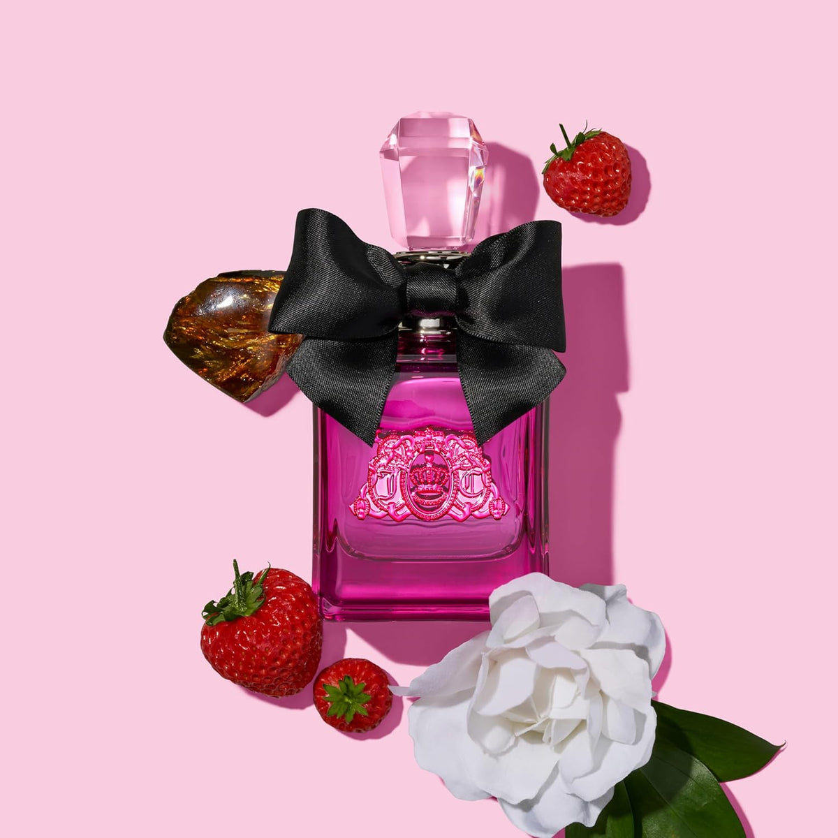 Refect Beauty Juicy Couture Viva La Juicy Noir perfume bottle with black bow, strawberries, and gardenia on pink