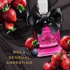 Refect Beauty Juicy Couture Viva La Juicy Noir perfume bottle with a black bow, surrounded by fresh berries.