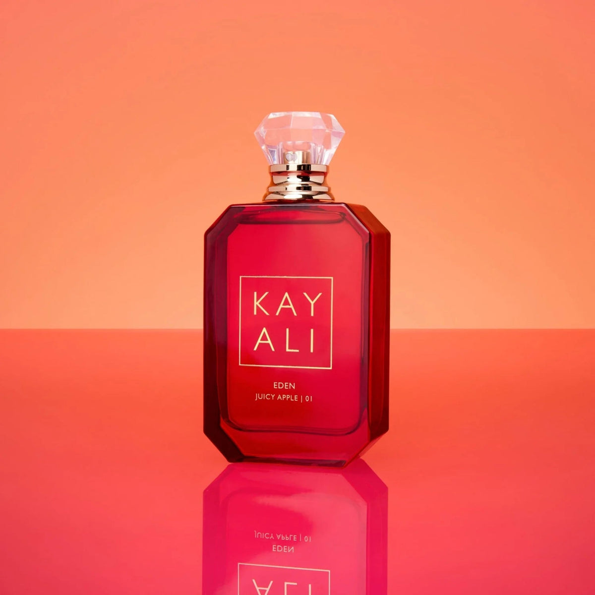Refect Beauty Kayali Eden Juicy Apple 01 eau de parfum in a vibrant red glass bottle with a crystal-like cap.