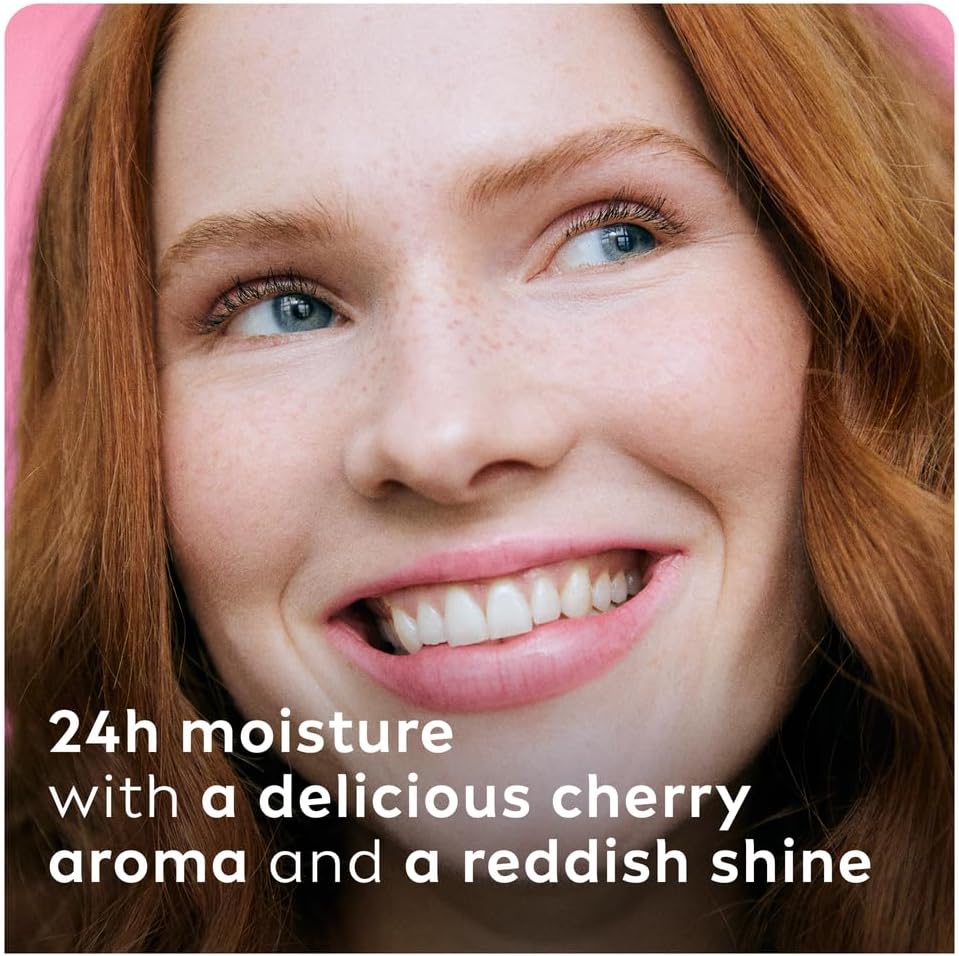 Refect Beauty Labello Shine Cherry lip balm on a smiling woman with red hair, showing a glossy reddish lip tint