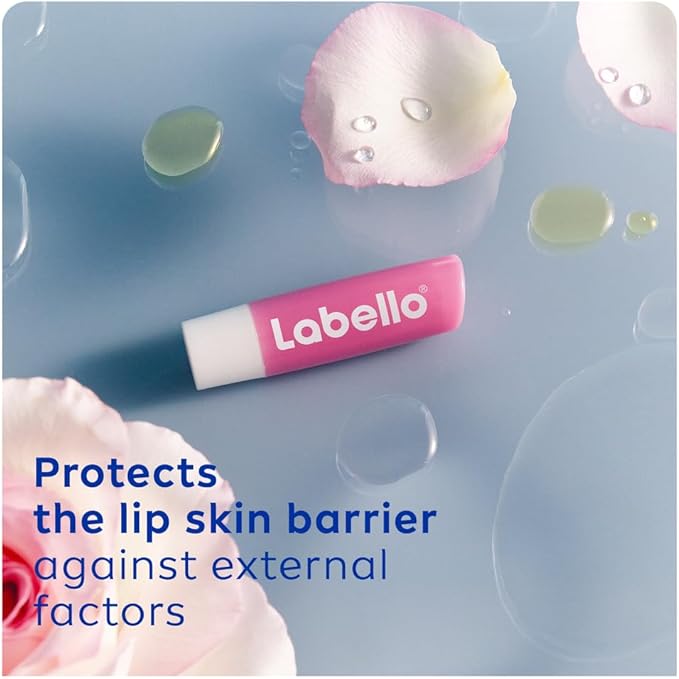 Refect Beauty Labello Soft Rose lip balm stick on a blue surface with rose petals and water droplets