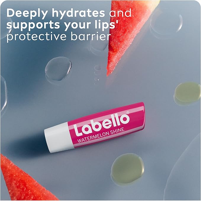 Refect Beauty Labello Watermelon Shine lip balm on a reflective surface with fresh watermelon slices