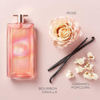 Refect Beauty Lancôme Idôle Nectar perfume bottle with rose, vanilla beans, and popcorn on a soft pink background.