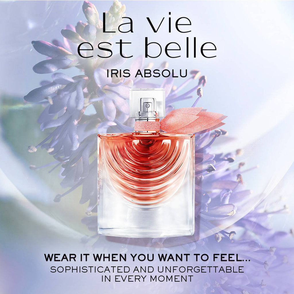 Refect Beauty Lancome La Vie Est Belle Iris Absolu perfume bottle with a pink ribbon against a purple iris background.