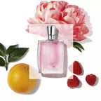Refect Beauty Lancome Miracle Eau de Parfum bottle surrounded by a pink peony, orange, and raspberries on white