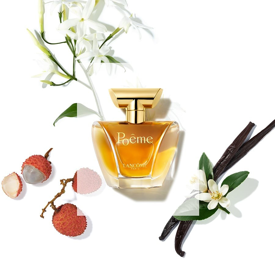 Refect Beauty Lancome Poeme Eau de Parfum bottle surrounded by lychee, vanilla beans, and white floral accents.