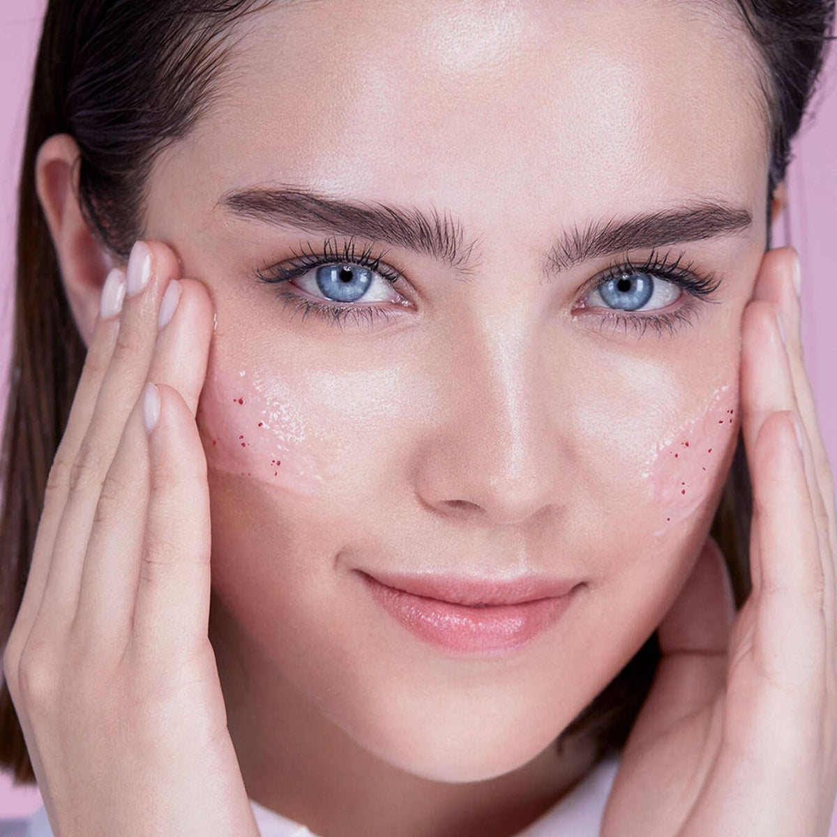 Refect Beauty model applying Lancome Rose Sugar Scrub to her cheeks for gentle facial exfoliation