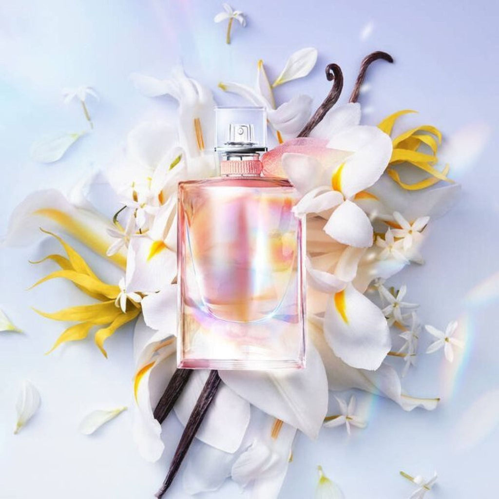 Refect Beauty Lancôme La Vie Est Belle Soleil Cristal perfume bottle surrounded by white flowers and vanilla beans
