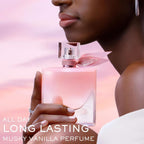Refect Beauty Lancôme La Vie Est Belle Vanille Nude perfume bottle held by a woman against a soft pink sunset sky
