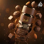 Refect Beauty Lattafa Asad Bourbon perfume bottle surrounded by floating chocolates and almonds in a warm brown setting.