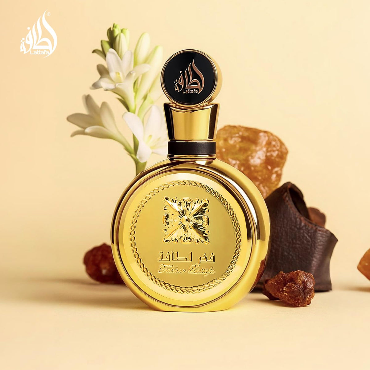 Refect Beauty Lattafa Fakhar Extrait perfume bottle in gold with tuberose flowers, leather, and amber on beige background