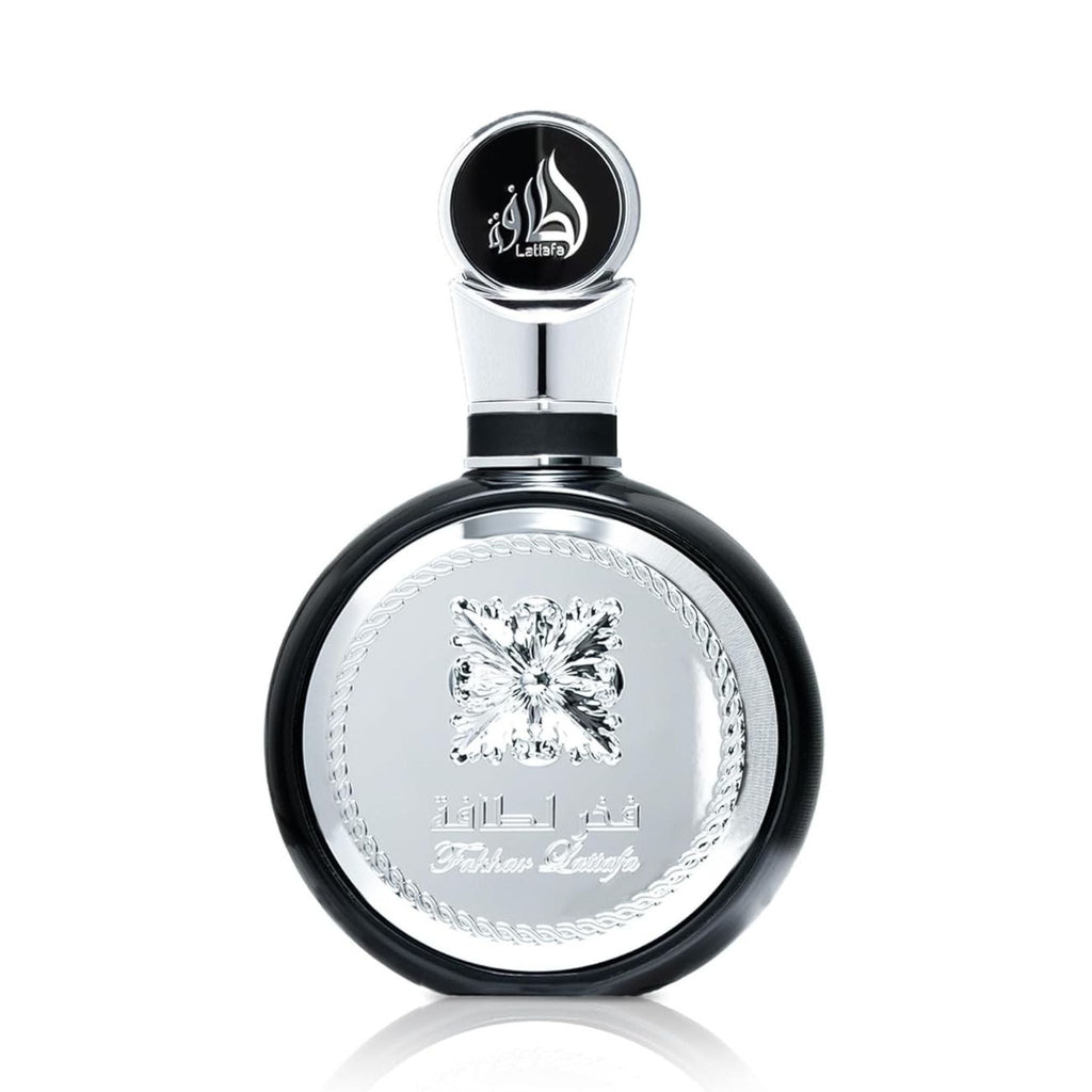 Refect Beauty Lattafa Fakhar Eau de Parfum in a sleek round black and silver bottle with elegant embossed detailing.